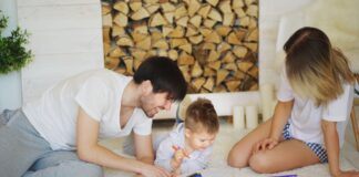 Rodzina rysująca razem na podłodze w salonie